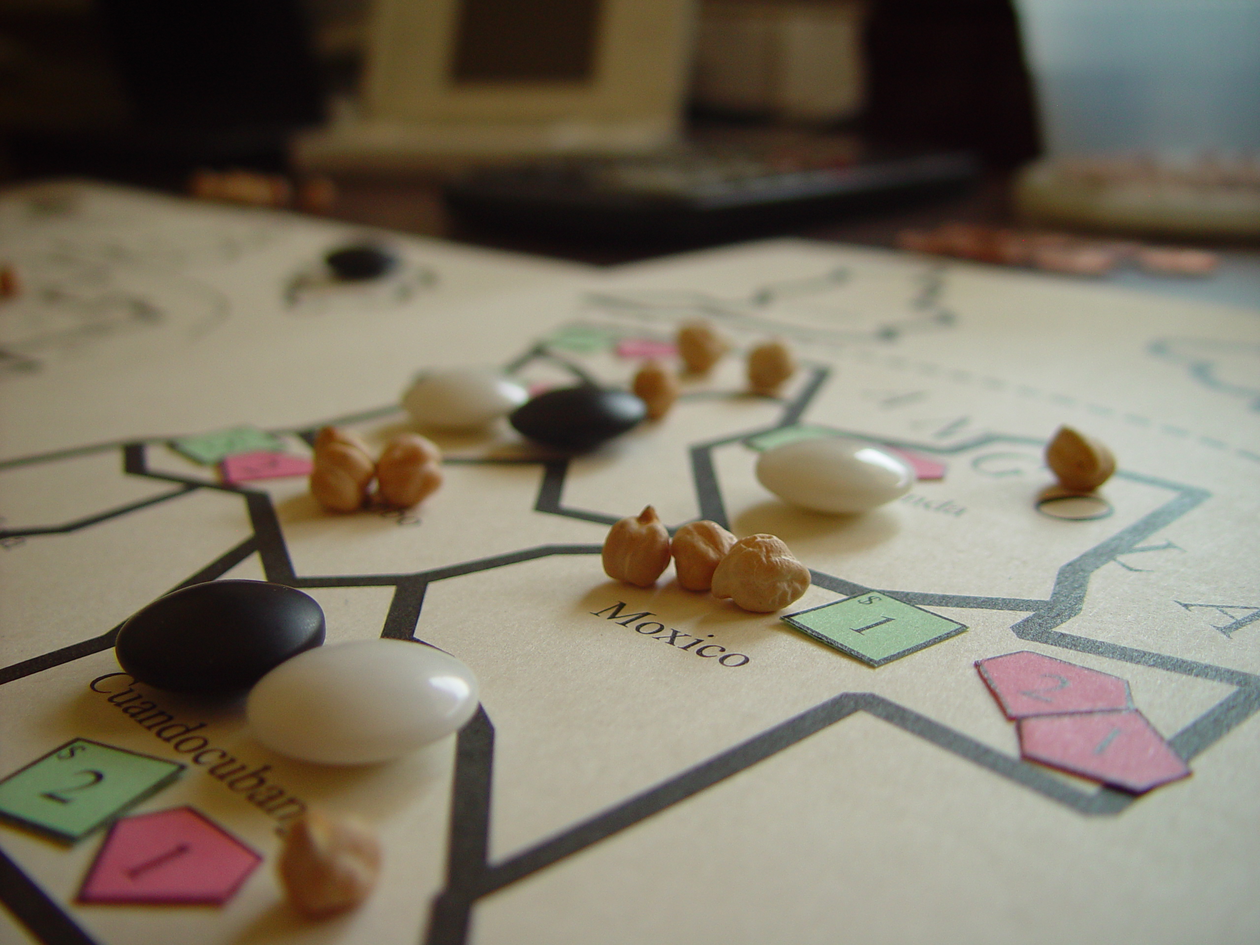 Paper prototype of Diamond Trust of London with a hand-drawn map, colored number tiles, beans and counters